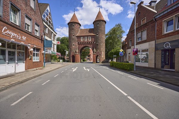 Lüdinghauser Tor town gate with Lüdinghauser Strasse and brick buildings in Dülmen, Münsterland,