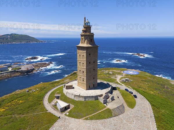 A striking lighthouse structure standing on a picturesque coastline surrounded by the deep blue sea