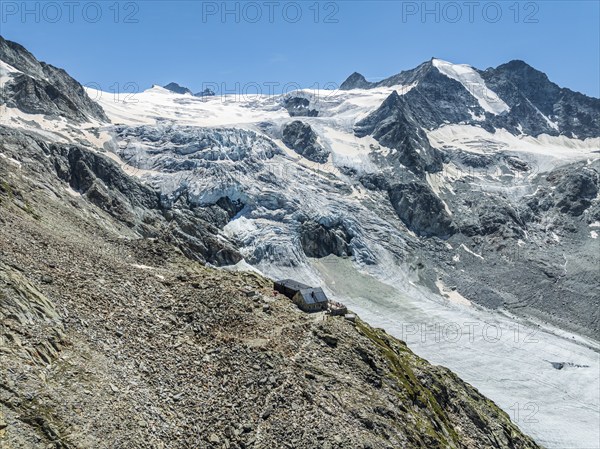 Mountain hut Cabane de Moiry, located close to the retreating Moiry glacier, hiking trail, aerial
