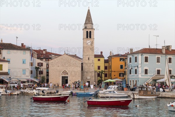 Fishing boats and colourful houses and church in Fazana, Istria, Croatia, Europe
