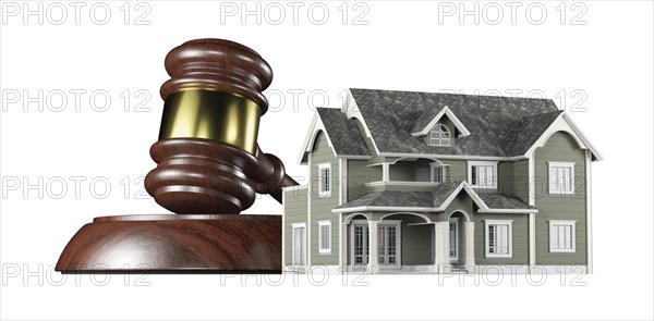 Wooden gavel and miniature house isolated on a white background