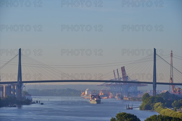 Köhlbrand Bridge over the Elbe, with passing ships and harbour cranes in the background, Hamburg,
