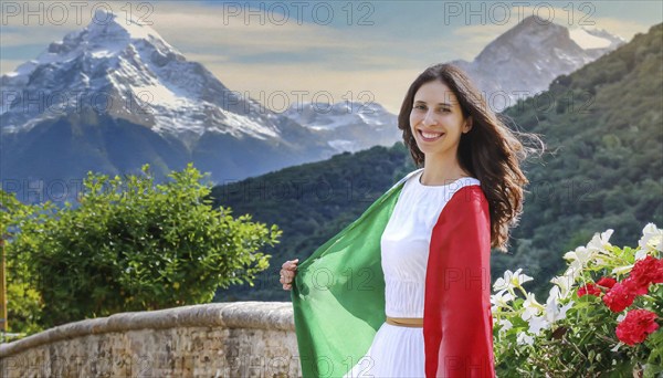 A smiling woman in a white dress holds the Italian flag with a mountain landscape in the