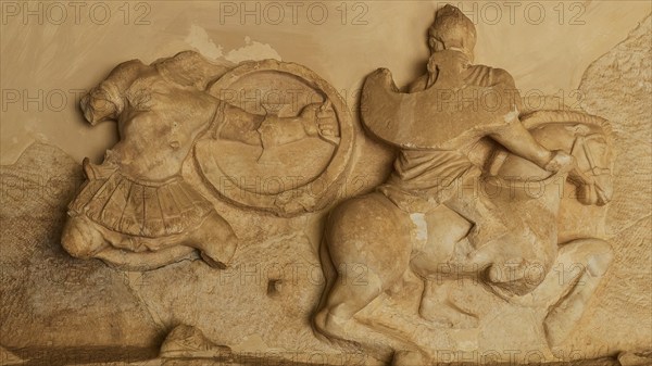 Stone relief of a horseman in battle, battle of the Greeks against the Amazons, richly detailed