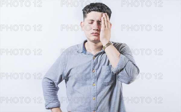 Exhausted person putting the palm of his hand on his face. Tired and exhausted man covering his
