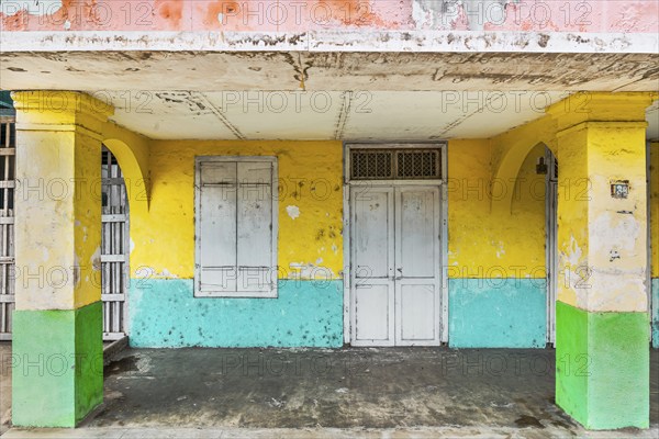Closed, dilapidated building with peeled off house wall in pastel shades, pastel, green,