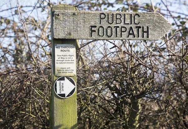 Close up wooden public footpath sign, no through route due to coastal erosion, River Deben,