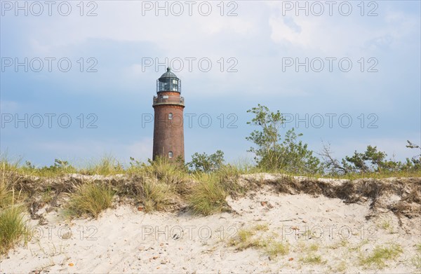 Lighthouse Darßer Ort behind dune with sparse vegetation, sand dune, Darsser Ort, cloudy sky,
