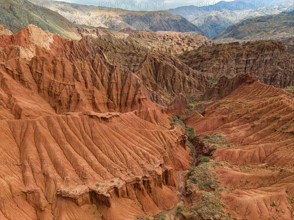Eroded mountain landscape, canyon with red and orange rock formations, aerial view, Konorchek