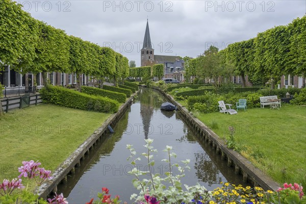 Church and river Ee with the bleaching meadows, Ijlst, province of Friesland, Netherlands
