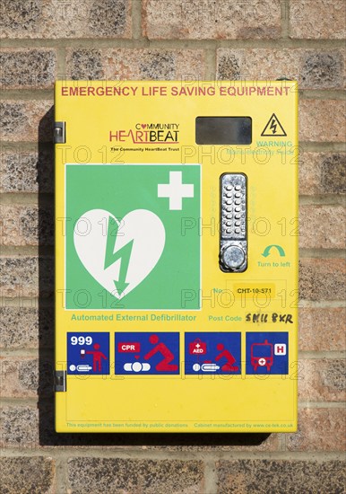 Automated External Defibrillator emergency life saving equipment mounted on wall, Community