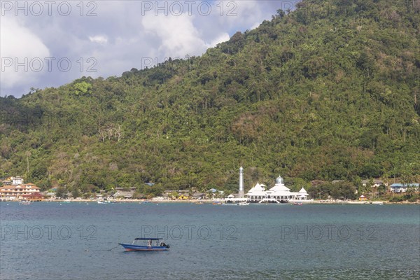 Green tropical island with a mosque on the coast.Malaysia