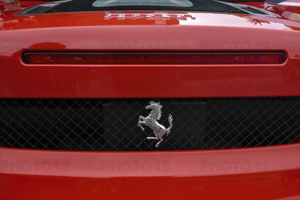 Close-up detail of red rear end of sports car Supercar Ferrari Spyder with logo trademark of luxury
