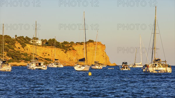 Sailing yachts in the bay of Talamanca, behind the rock Punta de s'Andreus, Eivissa, Ibiza Town,