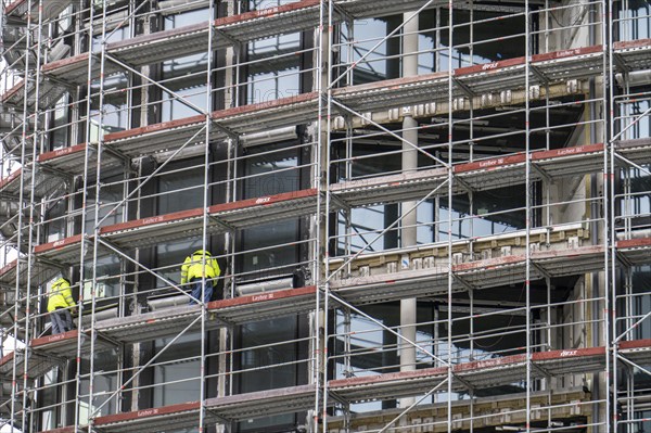 Large construction site, construction of a residential building with many flats, scaffolding,