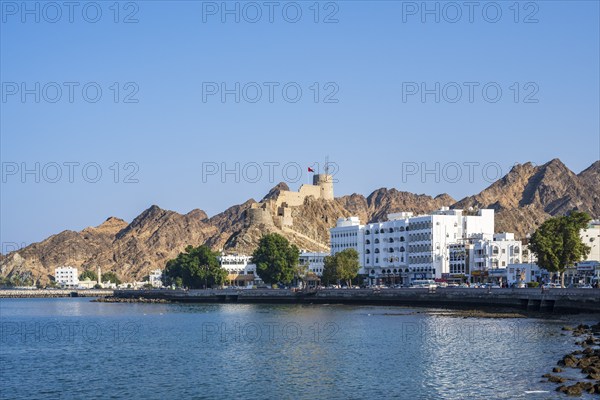 Mutrah Corniche with fort, promenade at the harbour, Matrah, Muscat, Oman, Asia