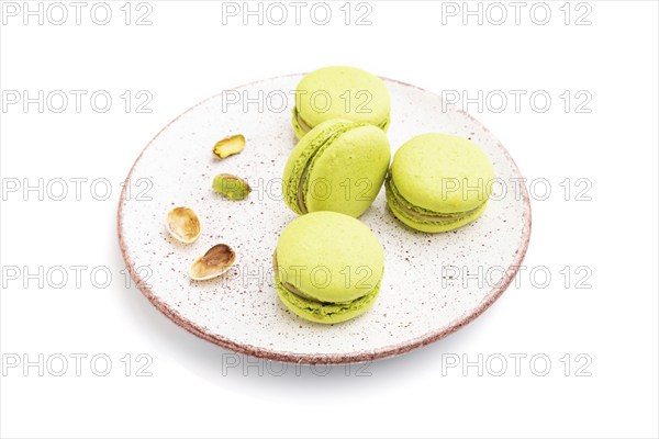 Green macarons or macaroons cakes isolated on white background. Side view, close up