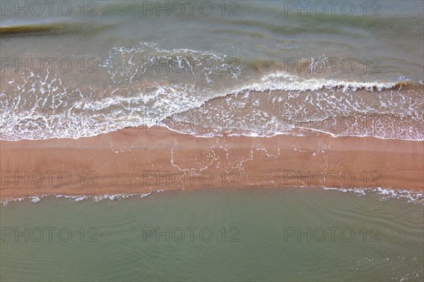 Aerial view at sea waves rolling in to a sand beach, Skagen, Denmark, Europe