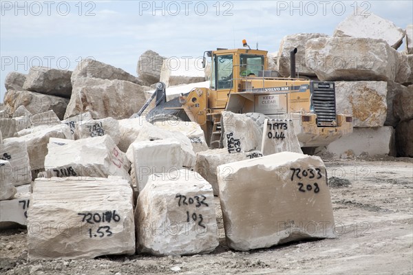 Heavy machinery at work in a stone quarry on the Isle of Portland, Dorset, England, UK