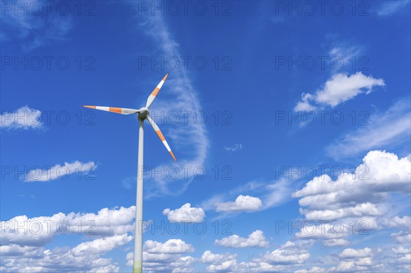 Wind turbine, wind energy plant from the manufacturer Enercon, blue sky with many white clouds,