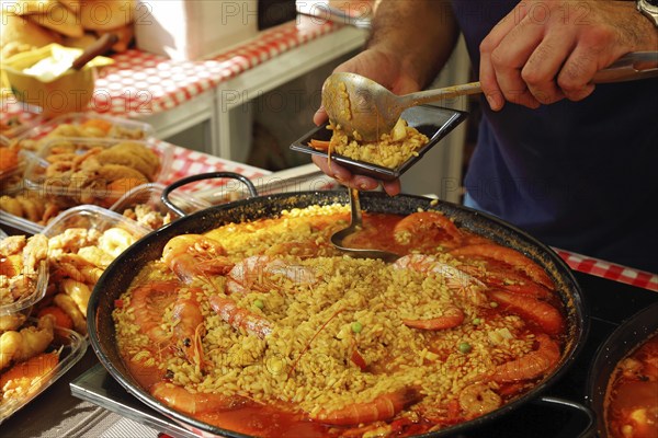 Paella preparation, street market stand near Barcelona Cathedral square