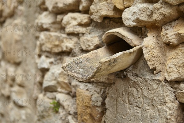 Natural stone wall with rainwater drain La Roque-sur-Cèze, Département Gard, Occitanie region,