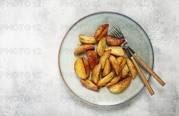 Fried potato slices, on a plate, top view, homemade, no people
