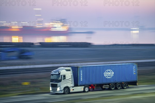 Lorry on the road to Euromax Terminal Rotterdam, ENECO wind farm on the dike around the port of