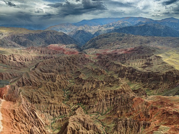 Eroded mountain landscape, canyon with red and orange rock formations, aerial view, Konorchek