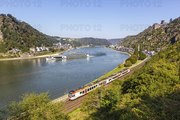 Stadler Flirt train regional railway Regional train of VIAS with river Rhine, castle Katz at the