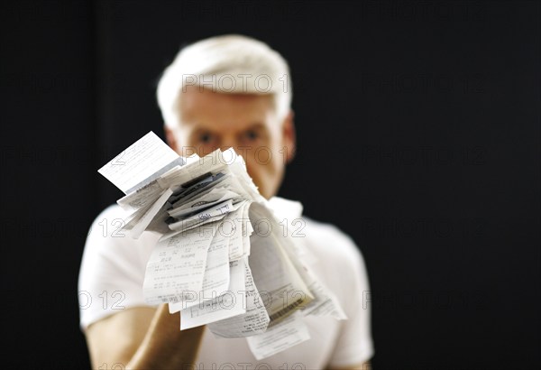 The subject of taxes. A man holds receipts in his hand in Berlin, 09/08/2024