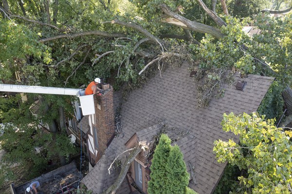 Detroit, Michigan, A worker dismantles a brick chimney after a storm with 70mph wind gusts blew