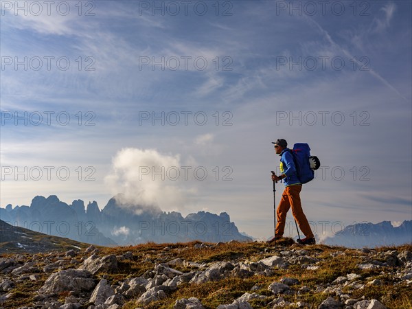Mountaineer with view of rose garden, Schlern, Dolomites, South Tyrol, Italy, Europe