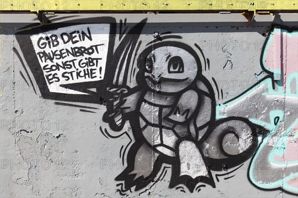Animal figure with stabbing weapon threatens knife violence at school, graffiti, Duisburg, North