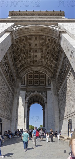 Tourists walk through the impressive Arc de Triomphe in Paris, Paris
