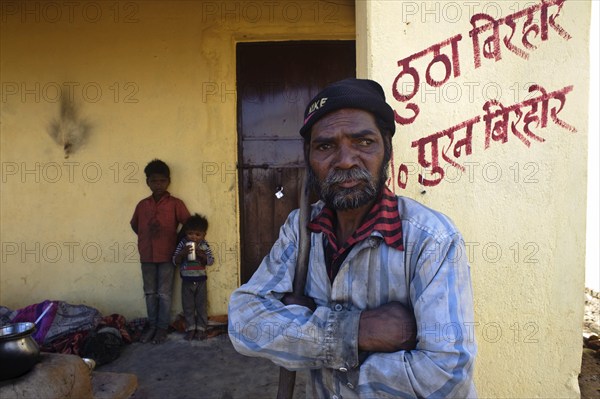 Portrait of a man and children belonging to the Birhor tribe, Jharkhand, India. They are standing