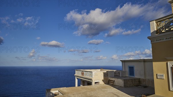 View of the vast sea and sky from a building with balcony, Colourful mountain village, Morning