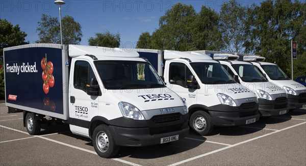 Parked Tesco home delivery vehicles advertised as offering a 'freshly clicked' service, UK