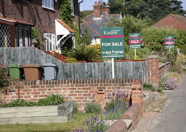 Estate agent signs and housing at Reedham, Norfolk, England, United Kingdom, Europe
