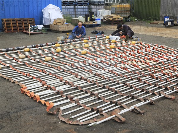 Men working on Dacon Rescue Scoop, Boston Putford Offshore Safety company, Lowestoft, Suffolk,