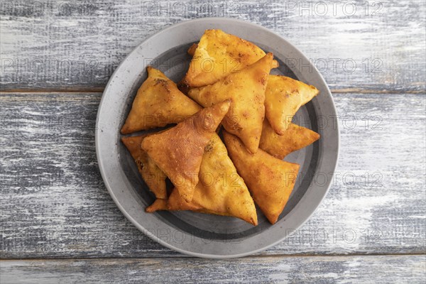 Nachos on a gray plate on a gray wooden background. Top view, close up