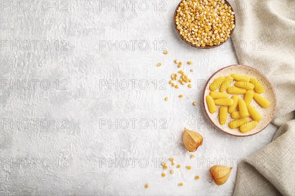 Jelly corn candies on gray concrete background and linen textile. top view, flat lay, copy space