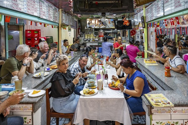 Visitors sitting at a table at a food stall, Mercado Central de San José, San José, Costa Rica,