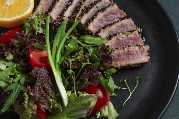 Vegetable salad, with fried tuna, in sesame seeds, healthy food, top view