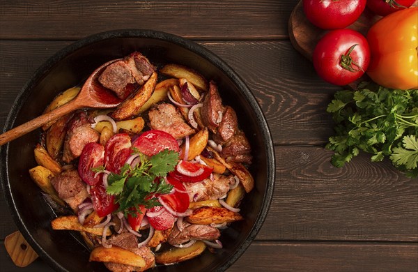 Ojakhuri, Traditional Georgian dish, fried potatoes with meat, in a clay frying pan, top view, no