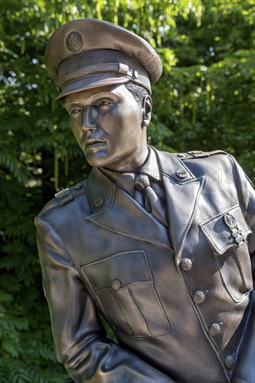Bronze statue, monument to rock singer Elvis Presley, King of Rock 'n' Roll in uniform of the 3rd
