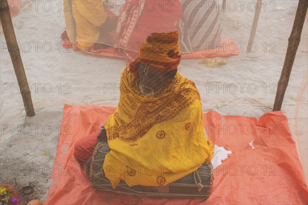 Devotees offer prayers at a tent city on the eve of consecration ceremony of the Ram temple, in