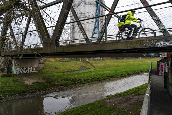 The River Emscher, sewage river, old railway bridge, now a footpath and cycle path, bridge for