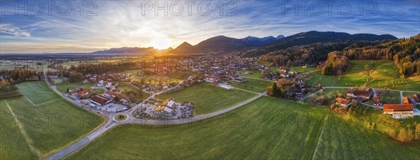 Panoramic view of a wide landscape with a village and mountains in the evening light, Bad Feilnbach