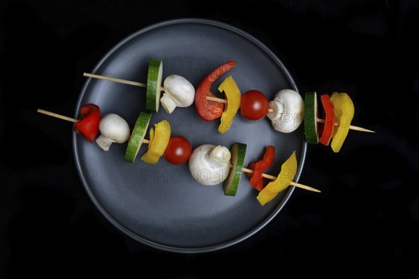 Colourful vegetable skewers on a plate, barbecue skewers
